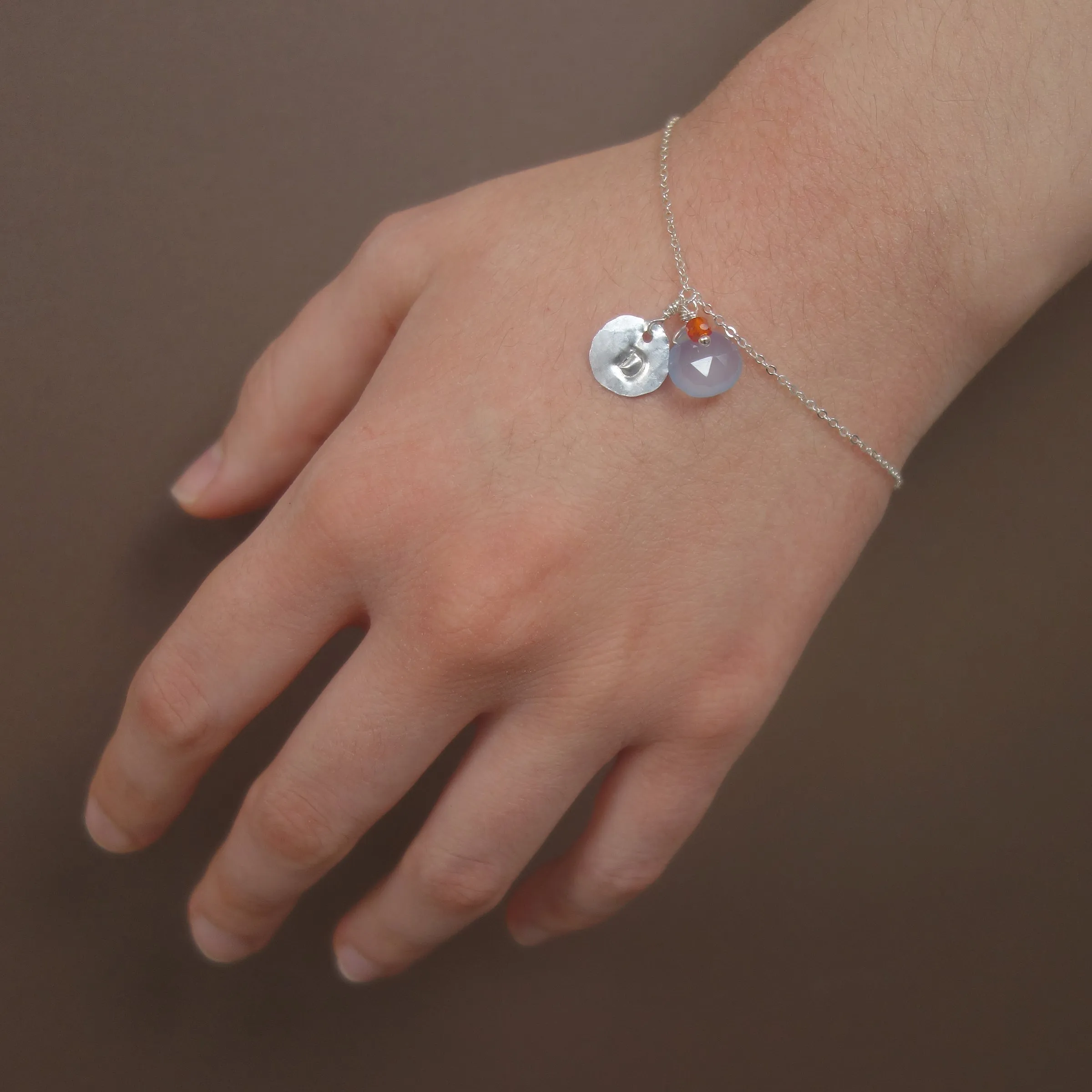 Hand stamped initial on silver/gold with briolette and gem (school colors)