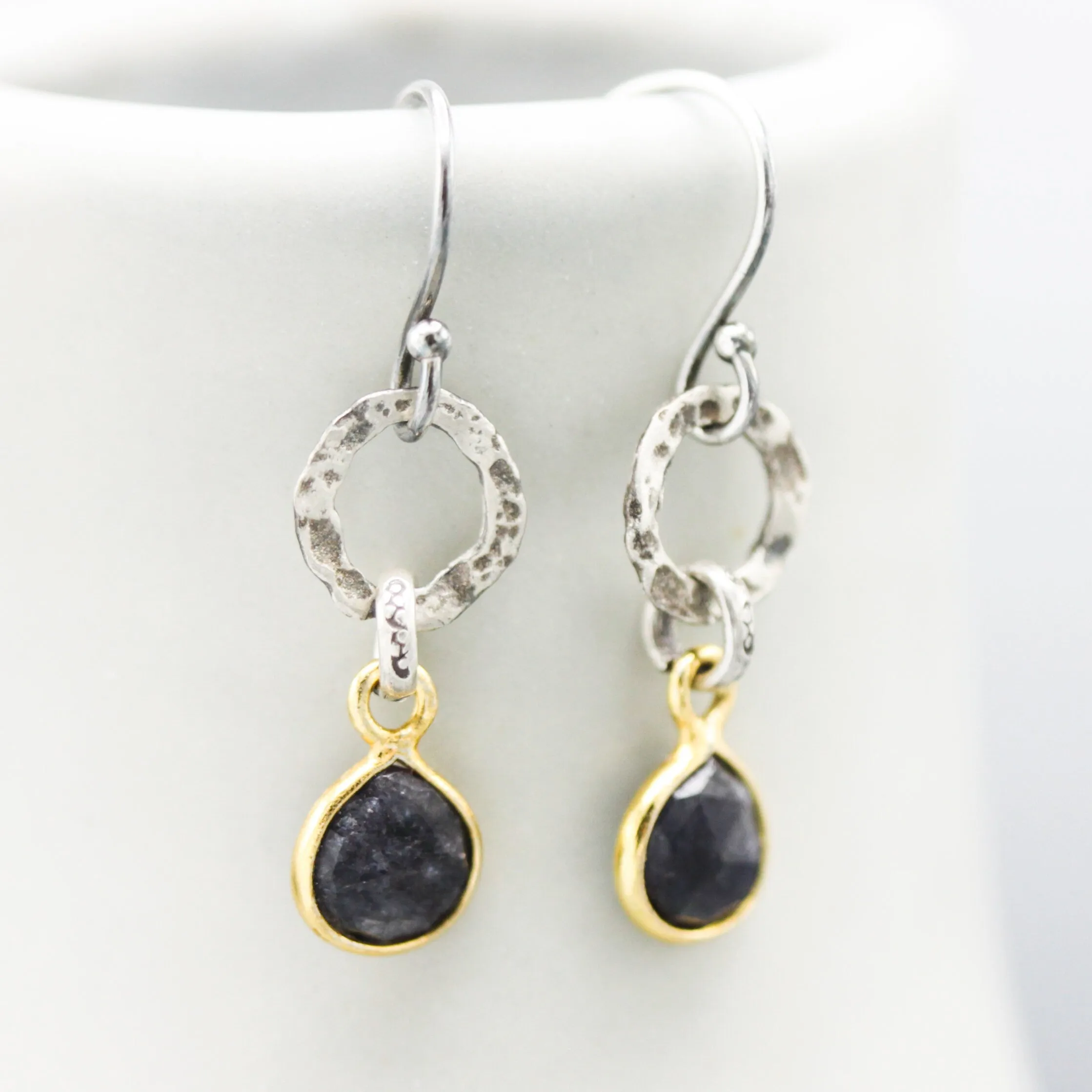Teardrop faceted blue sapphire earrings in silver bezel setting with silver circle shape and hooks style on the top