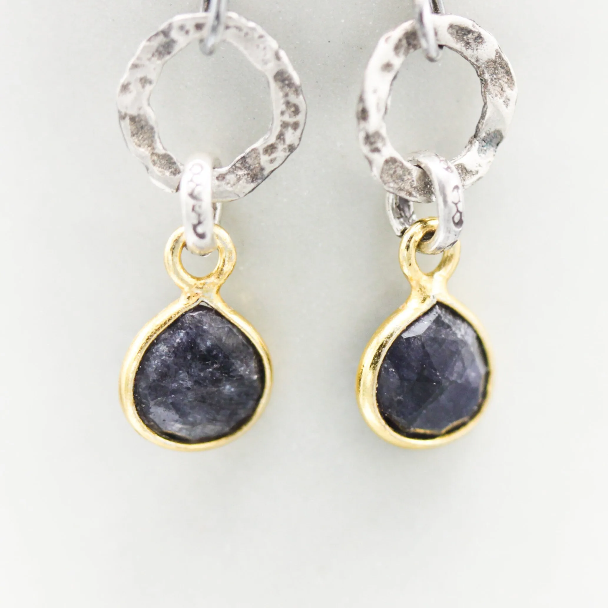 Teardrop faceted blue sapphire earrings in silver bezel setting with silver circle shape and hooks style on the top
